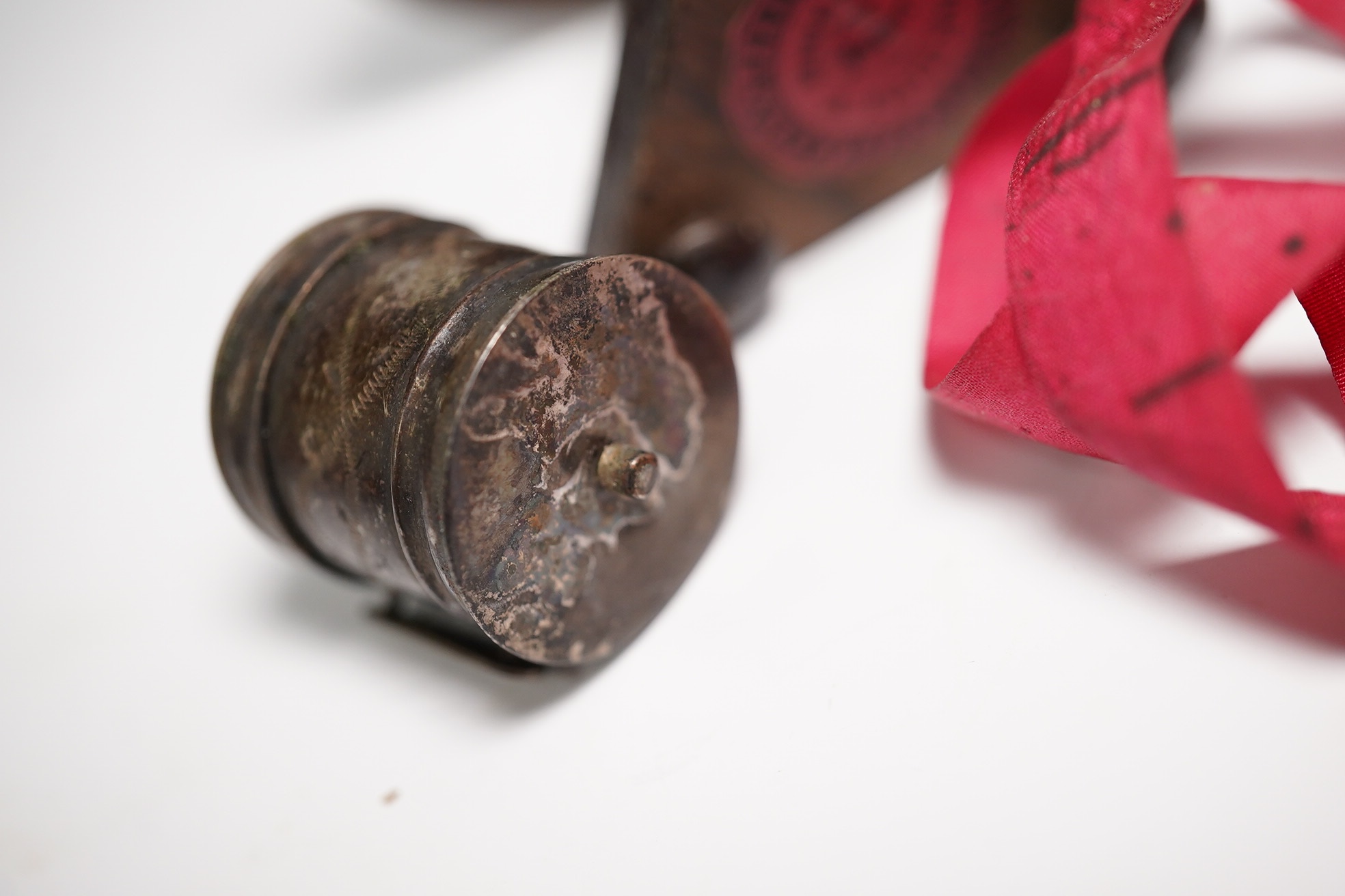 Two early Victorian white metal tape measures and a rosewood miniature 'table' pin cushion. Condition - fair